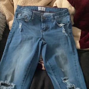 Blue skinny jeans , ripped from the bottom